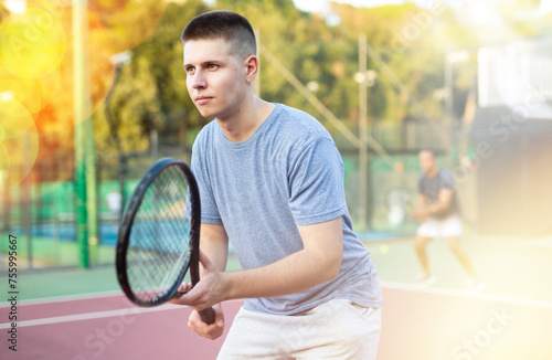 Concentrated young man tennis player hitting ball with a racket © JackF