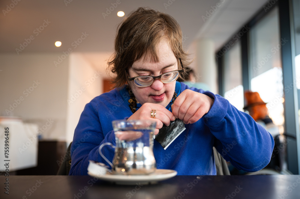 41 yo woman with the Down syndrome learning to brew tea, Belgium 41 yo woman with the Down syndrome learning to brew tea, Belgium