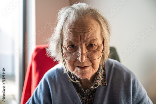 Portrait of an 85 yo white grandmother sitting, Tienen, Belgium photo