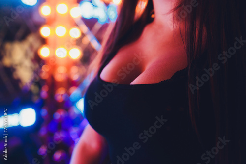 Decollete, female breast. Neckline black dress and fur collar.