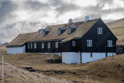 Traditional wooden farmhouse with grass roof on the Faroe Island of Vidoy photo
