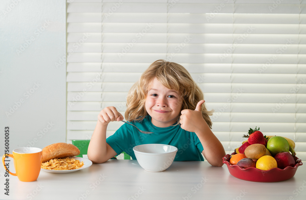 Schoolchild eating breakfast before school. Portrait of little teen child sit at desk at home kitchen have delicious tasty nutritious breakfast. Schoolchild eating breakfast before school. Portrait of little teen child sit at desk at home kitchen have delicious tasty nutritious breakfast.