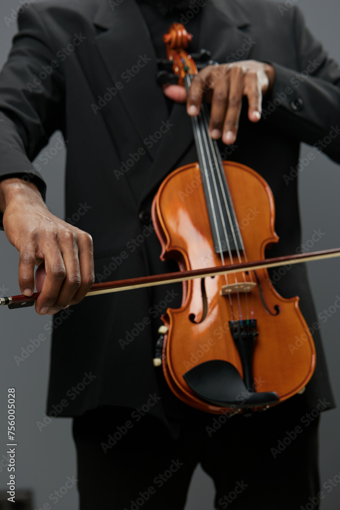 Elegant man in tuxedo holding violin against black background, classical music performance concept portrait concept Elegant man in tuxedo holding violin against black background, classical music performance concept portrait concept