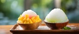 Traditional dessert made with two bowls of shaved ice topped with various ingredients, served on a wooden tray. A staple food in many Asian cuisines