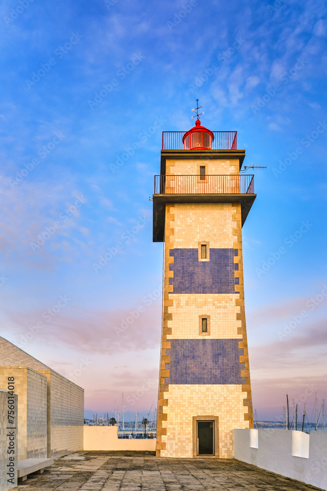 Upshot of lighthouse in Cascais, Portugal at sunset 