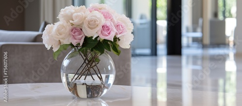 Elegant flowers displayed in a vase in a high-end home with marble flooring and white walls