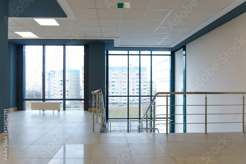 View of the empty spacious hall with large panoramic windows. Modern interior design of an empty office. A room with large windows.