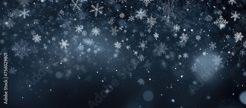 Electric blue snowflakes drizzling down on a dark background create a freezing precipitation event. Each transparent material drop shimmers with moisture