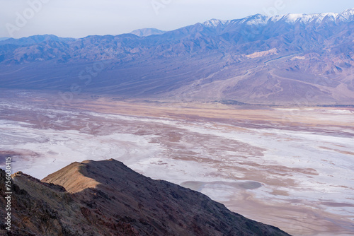Lake Manly forming in Badwater Basin after heavy rains in Death Valley National Park. Salt flats  snowcapped mountains   and desert valley views seen from Dante s View.