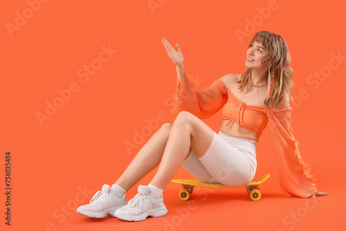 Young woman with skateboard...
