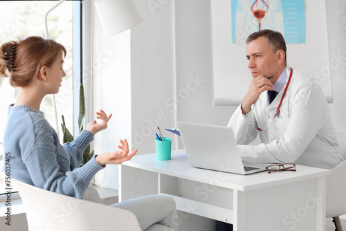 Mature doctor working with ...
