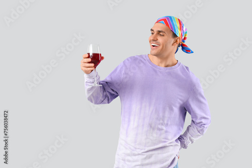 Young man with glass of win...