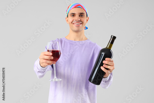 Young man with bottle and g...