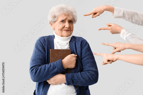 People pointing at senior w...