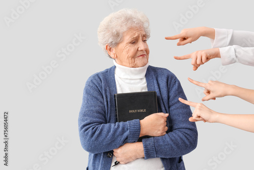 People pointing at senior w...