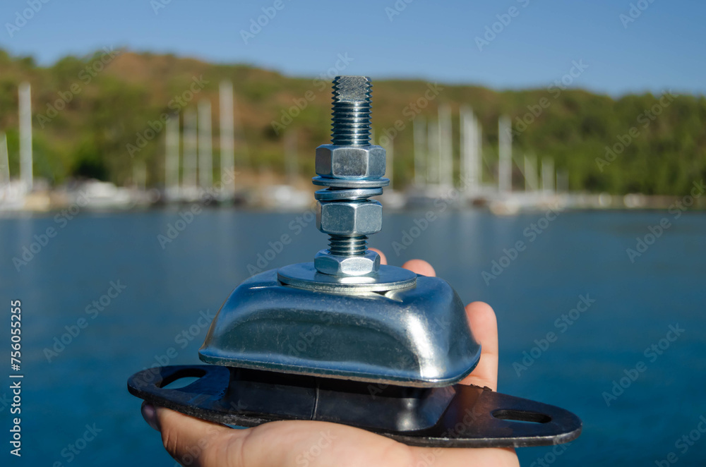 Obraz premium A new marine engine mount for a sailing yacht on the marina background.
