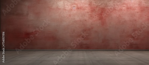 An empty room with a brown hardwood floor, featuring a peach colored rectangle pattern, contrasted against a red wall and dark tiled flooring