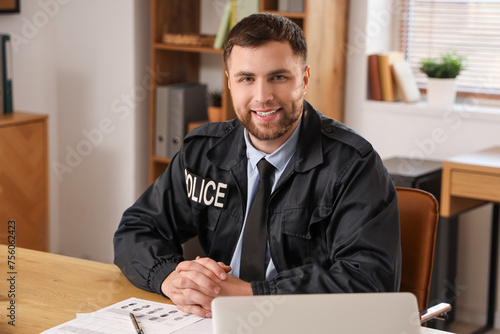 Male police officer sitting...
