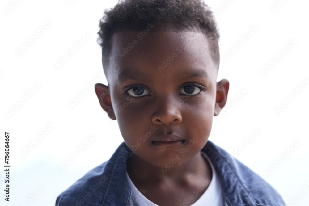Mixed race African and Asian boy is playing at the outdoor area. smiling happy boy has fun running on the beach. portrait of boy lifestyle with a unique hairstyle. Mixed race African and Asian boy is playing at the outdoor area. smiling happy boy has fun running on the beach. portrait of boy lifestyle with a unique hairstyle.