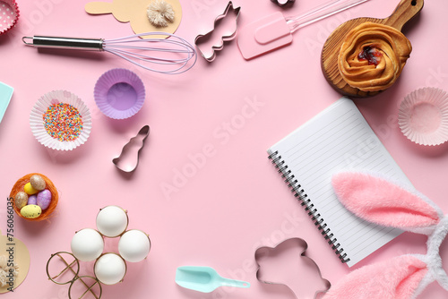 Blank notepad for recipes with sweet bun, Easter decor and baking tools on pink background