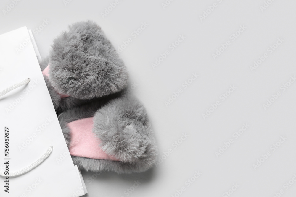 Shopping bag with fluffy Easter bunny ears on white background Shopping bag with fluffy Easter bunny ears on white background