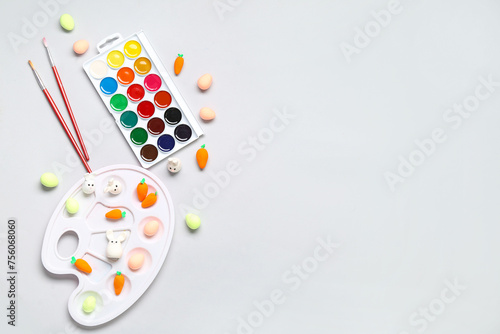 Decorative Easter eggs, watercolors and palette on white background. Easter concept.