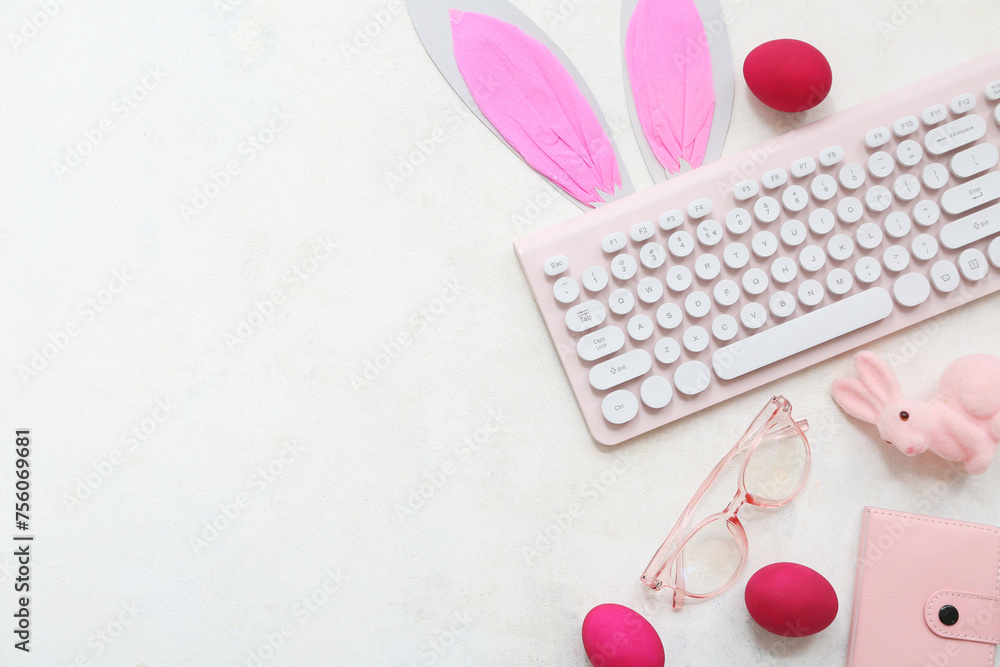 Composition with modern keyboard, eyeglasses and Easter decor on light background