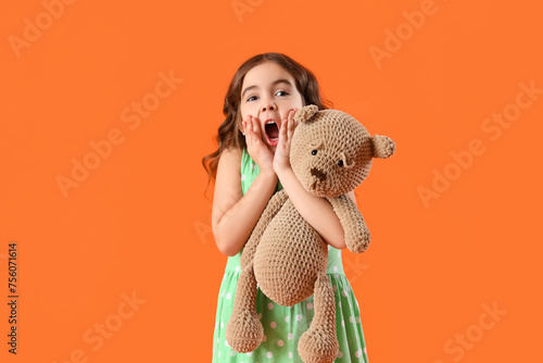 Shocked little girl with te...