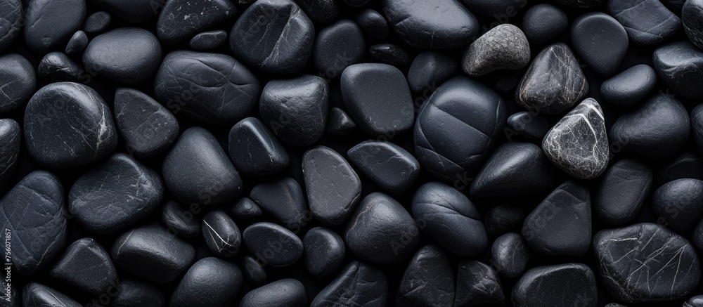 Closeup shot of a stack of dark stones resembling automotive tires, with a pattern similar to electric blue beans. The natural foods look like metal auto parts, giving off a mysterious vibe Closeup shot of a stack of dark stones resembling automotive tires, with a pattern similar to electric blue beans. The natural foods look like metal auto parts, giving off a mysterious vibe