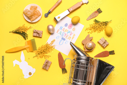 Composition with greeting card, beekeeping supplies and Easter decor on yellow background