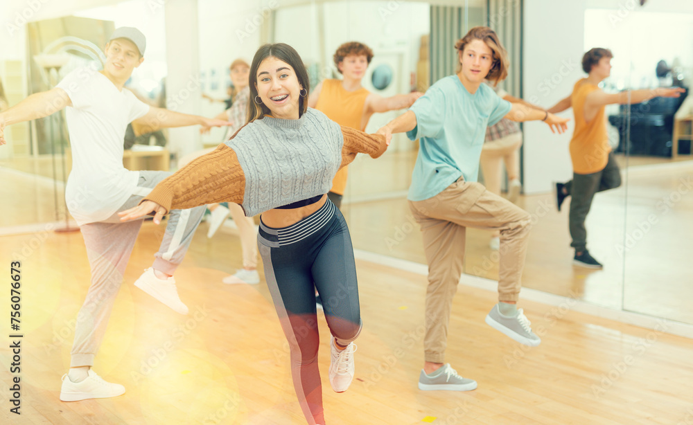 Energetic teenagers formed pairs and dancing swing in studio.