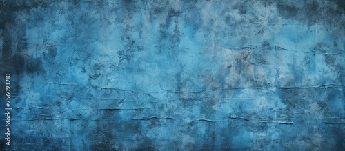 A close up of an electric blue background with a grunge texture resembling a natural landscape painting. The pattern resembles wood  rocks  freezing forest  and darkness