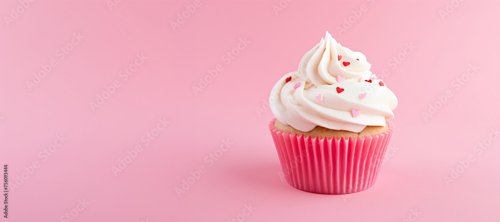 Cupcake with cream cheese frosting and sugar hearts on pink background. Valentine's day or birthday dessert. Festive food for wedding or baby shower. Banner with copy space Cupcake with cream cheese frosting and sugar hearts on pink background. Valentine's day or birthday dessert. Festive food for wedding or baby shower. Banner with copy space