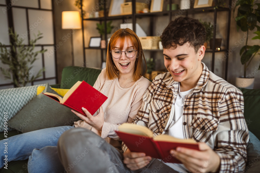 man and woman caucasian adult couple read books at home on sofa bed man and woman caucasian adult couple read books at home on sofa bed