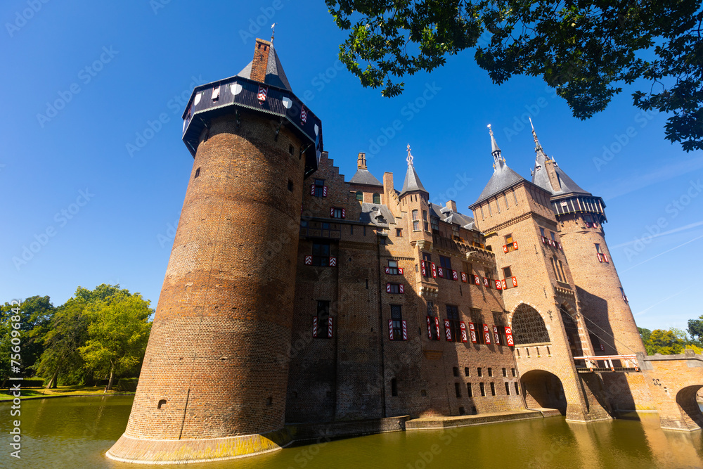 De Haar Castle from outside during daytime under clear deep blue sky. Utrecht, Netherlands.
