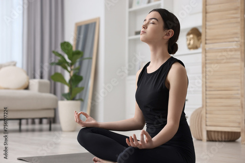 Beautiful girl meditating at home. Practicing yoga Free Download Beautiful girl meditating at home. Practicing yoga - GFXLoad