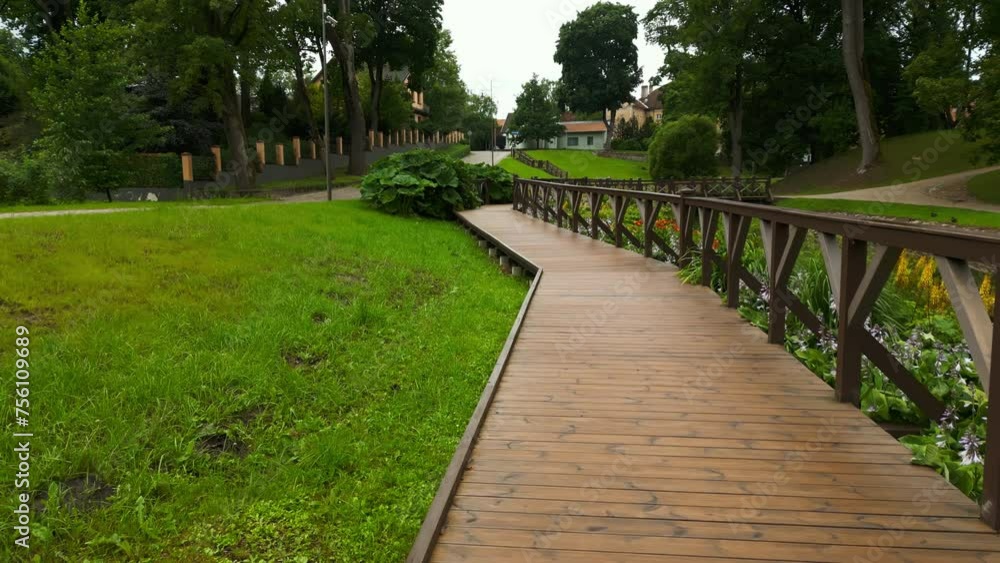 Overhead waterside dwelling: Aerial view captures a building situated beside a watercourse featuring a bridge, contributing to the charm of the natural landscape