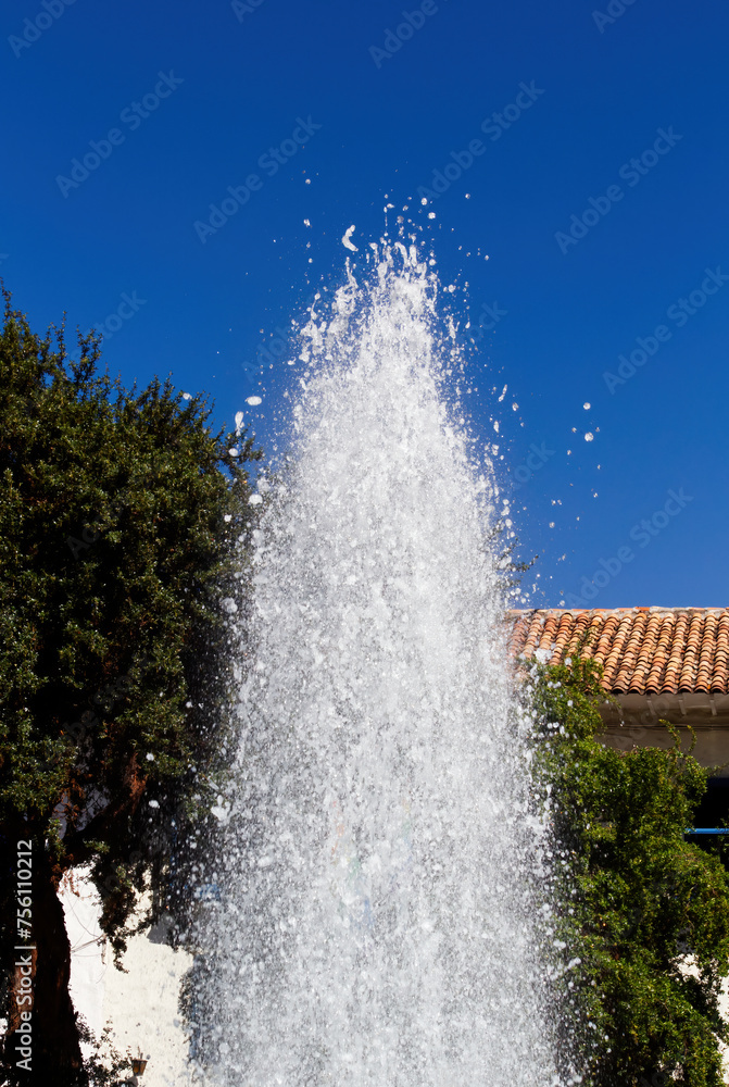 Naklejka premium Water Spraying Into Air From Plaza Fountain Cusco Peru