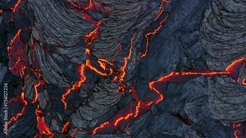 A 4K drone captures aerial cinematic close-up shots of both lava stones and the live lava flowing in between them.