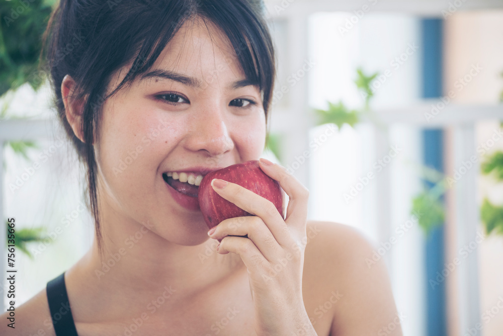 young asian woman eating Apple Healthy. Girl workout holding organic apple fruit healthy lifestyle. Wellness Asian women eat red apple smile face look at camera. Beauty health care lifestyle concept young asian woman eating Apple Healthy. Girl workout holding organic apple fruit healthy lifestyle. Wellness Asian women eat red apple smile face look at camera. Beauty health care lifestyle concept