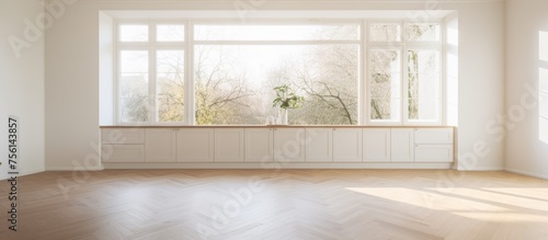 Empty white kitchen with wooden parquet floor and windows