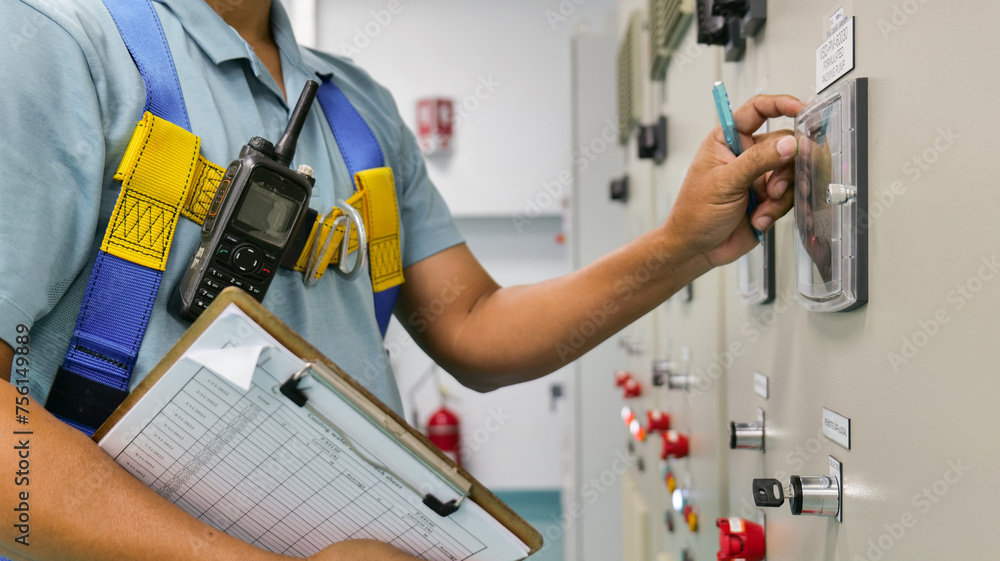 Fototapeta premium A man is writing on a control panel