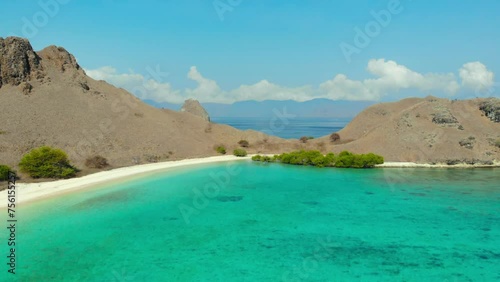 Turquoise Sea With Shallow Waters At Pink Beach On Komodo Island In Indonesia. drone pullback shot photo