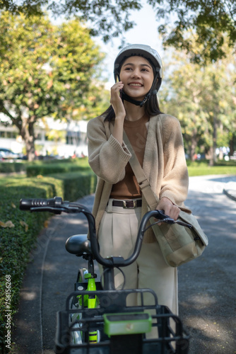 bicyclist Caucasian woman in casual clothes and helmet walking chill in the park city