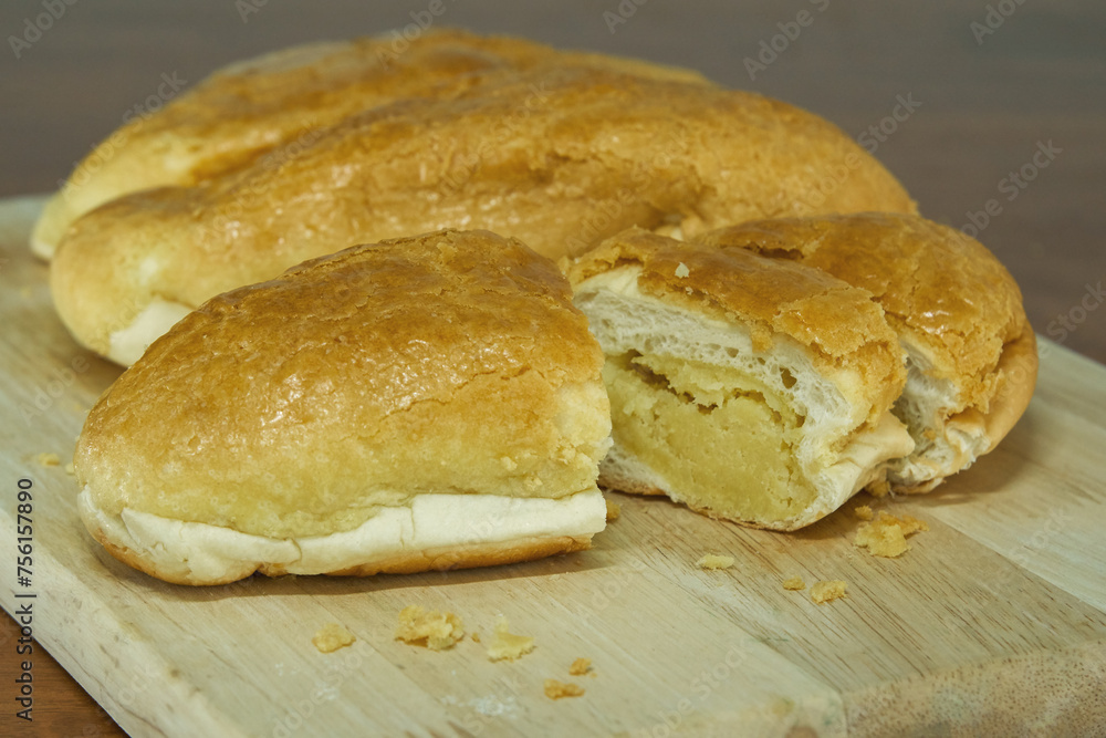 Butter bread bun on wooden board.