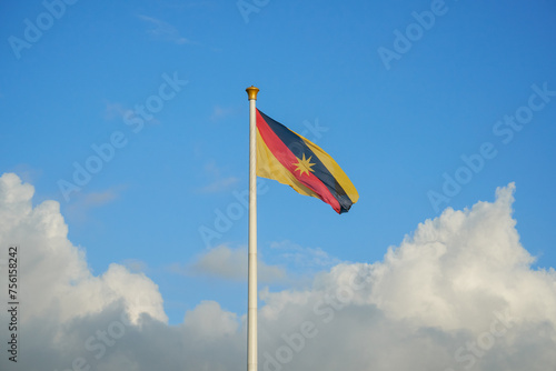 Tallest flagpole in South East Asia fly Sarawak flag with a blue sky and cloud.