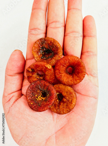 Dried figs on hand palm dry fruit food with crunchy seeds afghani brown fig sukha anjeer closeup view image picture stock photo.