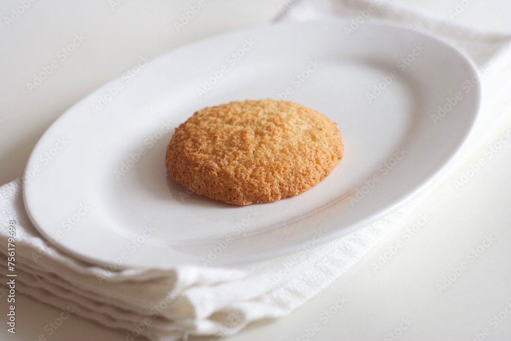 Coconut cookies in a plate on a white table Coconut cookies in a plate on a white table
