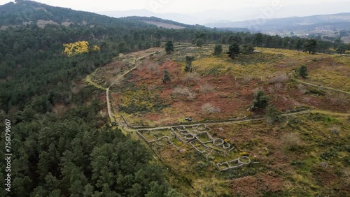 Drone descends to rock wall pathway of Castro de San Cibran in Las Ourense Spain photo