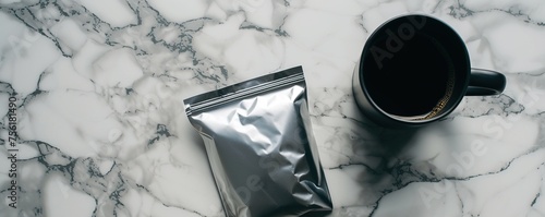 Coffee powder packaging and cup of coffee on marble table